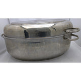 A large oval stainless steel pot with a matching lid, featuring two side handles, shown on a white surface against a white background.